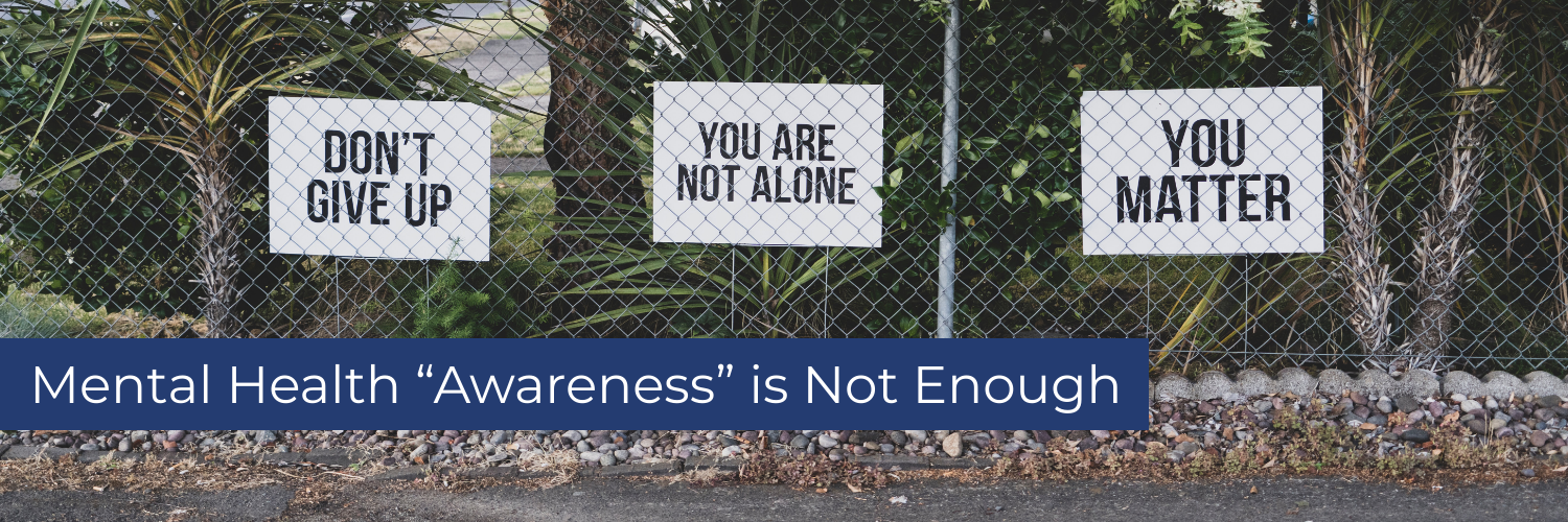 Signs of mental health encourangement on a fence and 